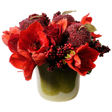 Holiday Christmas arrangement monochromatic red featuring amaryllis, red roses, red berries, red sparkling decorative accent arranged in Flower Studio signature style.